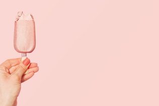 Young woman holding pink ice cream