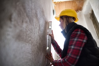 Young woman worker on the construction site.