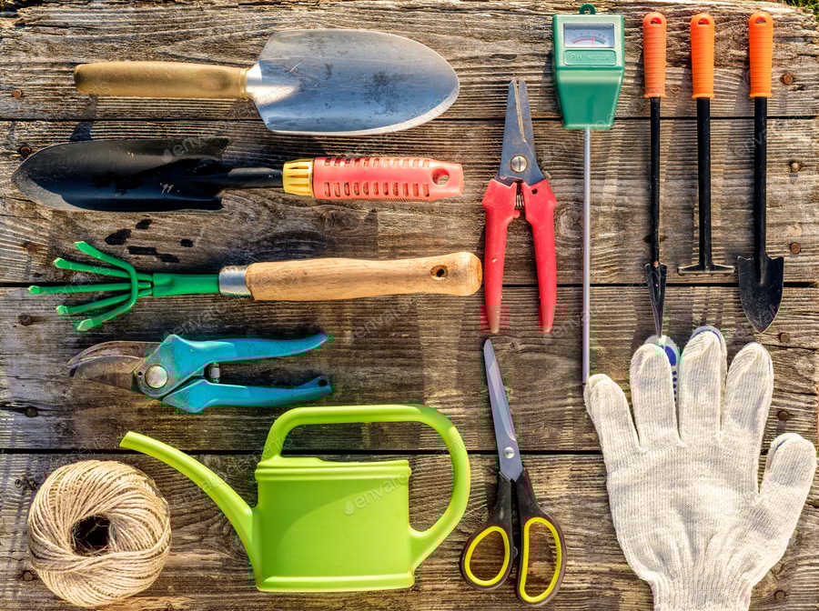 Gardening tools on wooden background flat lay