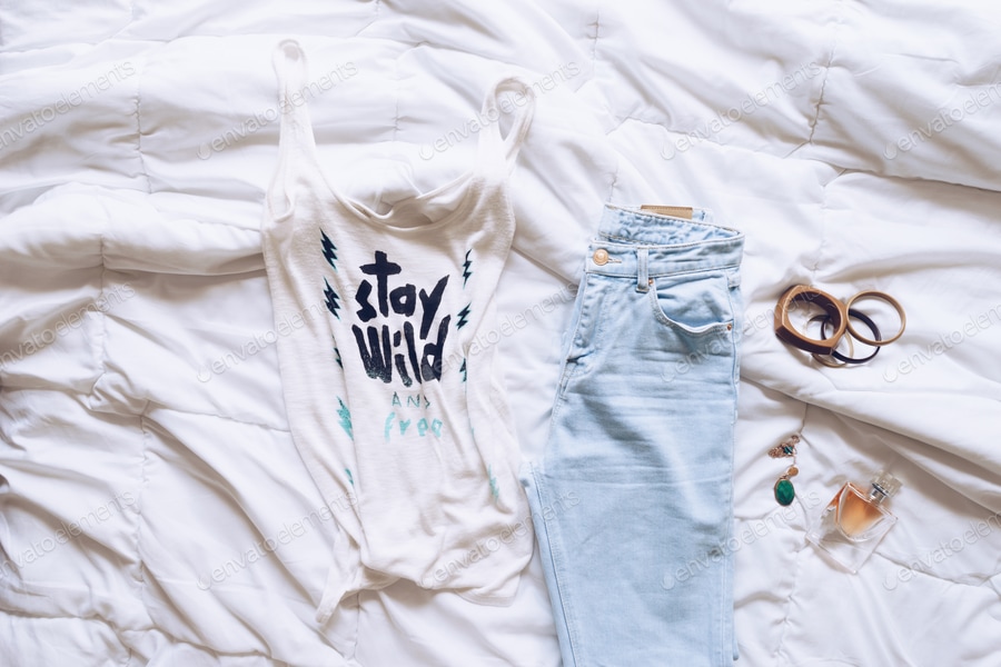 Female outfit laid out on bed, morning light