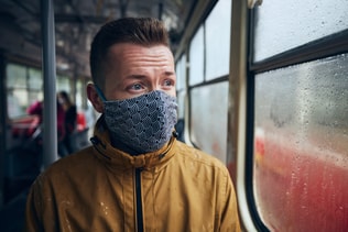 Man wearing face mask in public transportation