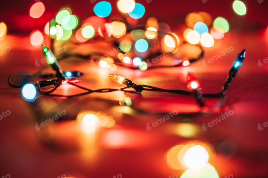 Cover for blurred shining colourful garlands as christmas background