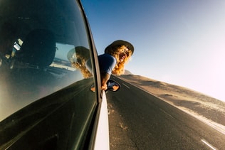 Happy traveler caucasian adult woman outside the car