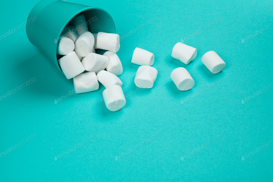 Cover for marshmallow laid out on blue paper background. pastel creative textured pattern