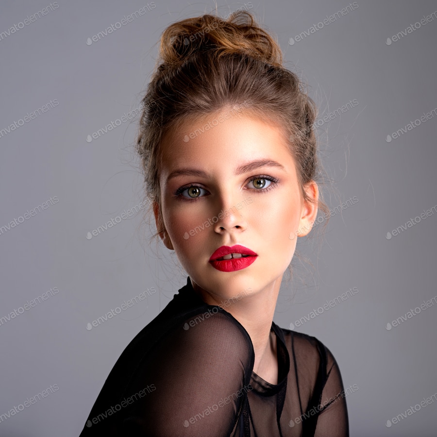 Cover for Beautiful photoshopped brown-hair girl. Attractive girl with bright makeup looking at the camera.
