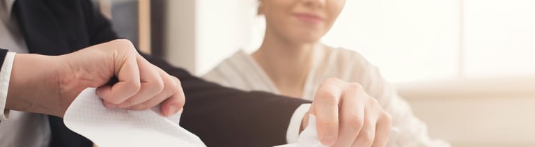 Angry businessman tearing up a document