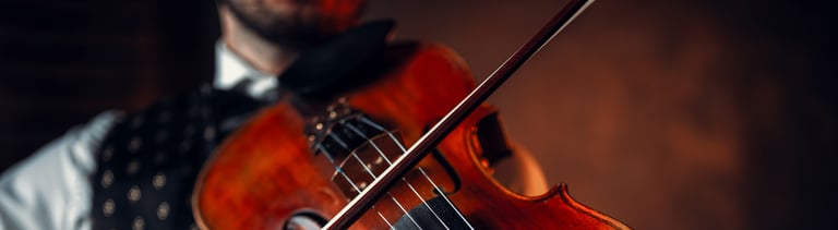 Male violinist playing classical music on violin