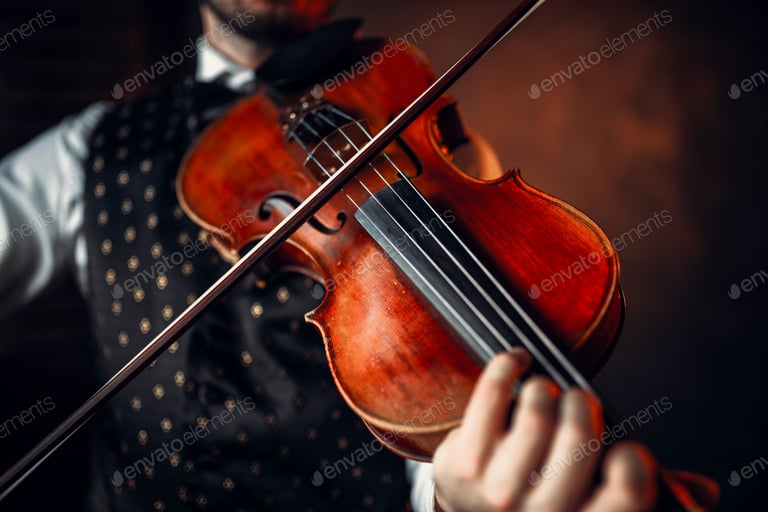 Male violinist playing classical music on violin
